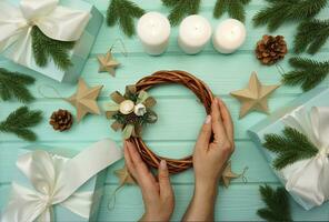 A woman is engaged in making a Christmas wreath. The concept of preparing for the Christmas holiday. photo