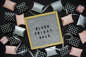 The inscription black Friday sale in a frame, there are shopping boxes around photo