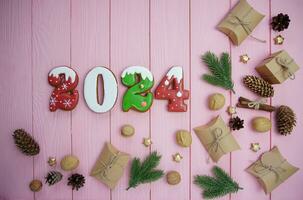 The numbers are gingerbread 2024 on a pink background. photo