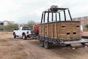 Car, Truck Ride With Hot Air Balloon Basket On Car Trailer, Preparing To Fire Up Balloon In The Field. Equipment Baskets, Propellers, Gas Burner And Canopy Package. Horizontal Plane photo