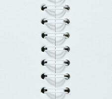 Open spiral notepad with blank white sheets photo
