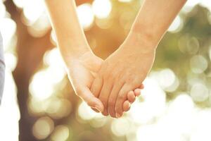 Woman and man holding hands, Happy couple love in the garden. concept couple lover valentine day photo