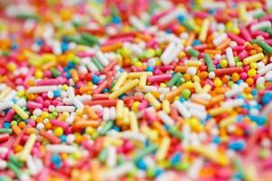 Toppings for donuts, desserts and ice cream on pink background. photo