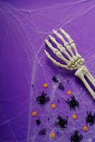 Happy Halloween banner mockup, pumpkins, bats and spiders on purple background photo