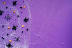 Happy Halloween banner mockup, pumpkins, bats and spiders on purple background photo