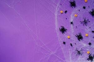 Happy Halloween banner mockup, pumpkins, bats and spiders on purple background photo