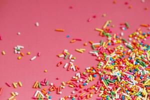 Toppings for donuts, desserts and ice cream on pink background. photo