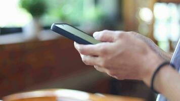 Hands of woman holding smartphone, using online app and virtual services cellphone, texting and chatting on messengers, buying online, reading books, articles. Close up video