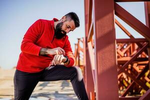 Adult man is ready for exercising outdoor on sunny day. photo