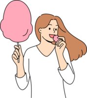 Woman eats cotton candy, enjoying airy sugar dessert while walking in park or at fair png