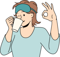 Woman drinks morning coffee after waking up and shows ok gesture standing in sleep mask png