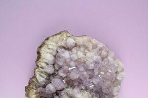 Natural amethyst druse geode mineral crystal unpolished semi-precious gemstone. Magic rock for ritual, witchcraft, spiritual practice, meditation. Esoteric life balance concept. Copy space photo
