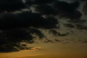 Stormy sky with dark clouds. Natural background. Sky background. Cloudscape, Colored Sunset. photo