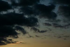 Stormy sky with dark clouds. Natural background. Sky background. Cloudscape, Colored Sunset. photo