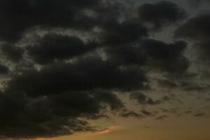 Stormy sky with dark clouds. Natural background. Sky background. Cloudscape, Colored Sunset. photo