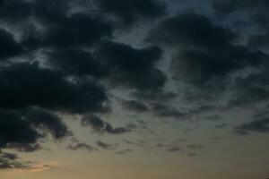 Stormy sky with dark clouds. Natural background. Sky background. Cloudscape, Colored Sunset. photo