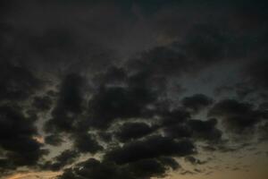 Stormy sky with dark clouds. Natural background. Sky background. Cloudscape, Colored Sunset. photo