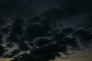 Stormy sky with dark clouds. Natural background. Sky background. Cloudscape, Colored Sunset. photo