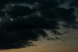 Stormy sky with dark clouds. Natural background. Sky background. Cloudscape, Colored Sunset. photo