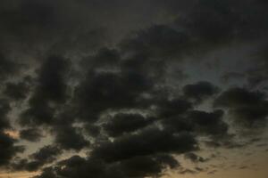 Stormy sky with dark clouds. Natural background. Sky background. Cloudscape, Colored Sunset. photo