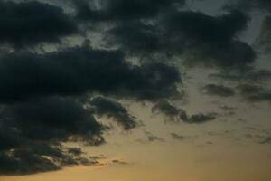 Stormy sky with dark clouds. Natural background. Sky background. Cloudscape, Colored Sunset. photo