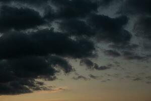 Stormy sky with dark clouds. Natural background. Sky background. Cloudscape, Colored Sunset. photo