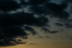 Stormy sky with dark clouds. Natural background. Sky background. Cloudscape, Colored Sunset. photo