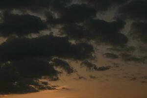 Stormy sky with dark clouds. Natural background. Sky background. Cloudscape, Colored Sunset. photo