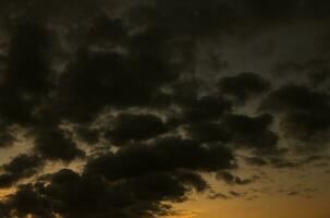 Stormy sky with dark clouds. Natural background. Sky background. Cloudscape, Colored Sunset. photo