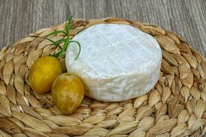 Brie cheese with yellow plums photo