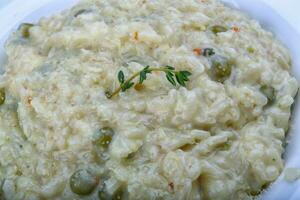 Risotto with cheese and green peas photo