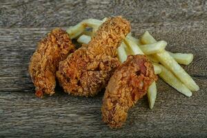 Chicken with fry potato photo