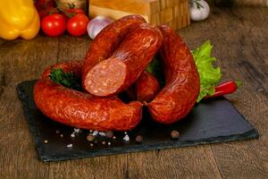 Pork sausages over wooden photo