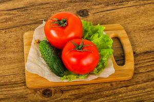 Cucumbers and tomatoes photo