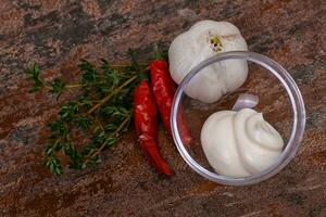 Mayonnaise sauce in the white bowl served thyme and garlic photo