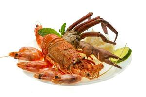 Spiny lobster, shrimps, crab legs  and rice photo