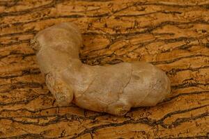 Ginger root over the wooden photo