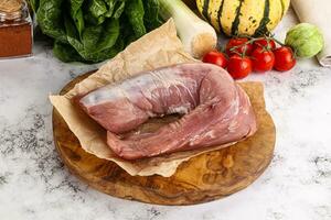 Uncooked raw pork tenderloin with spices photo