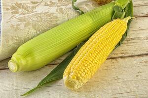 Yellow sweet raw cob corn photo