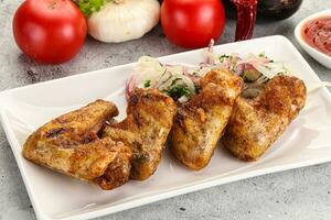 Grilled chicken wings with sauce photo