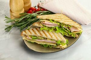 Homemade club sandwich with ham and cheese photo