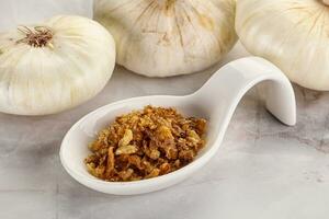 Dried roasted onion flakes for culinary photo