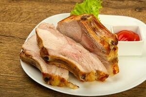 Roasted pork on wooden background photo