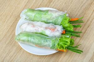 Spring rolls on wooden background photo