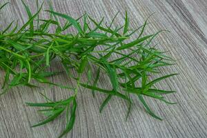 Tarragon on wooden background photo