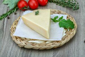 Parmesan cheese on wooden background photo