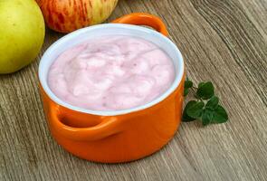 Srawberry yoghurt on wooden background photo