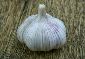 Garlic on wooden background photo