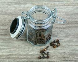 Cloves seeds on wooden background photo