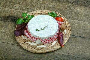 Camembert on wooden background photo